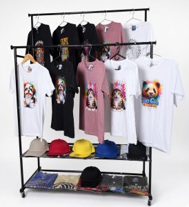 Clothing rack filled with colorful printed T-shirts and caps